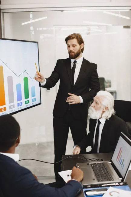 A modern office setup featuring a laptop and a whiteboard schedule for social media platforms.