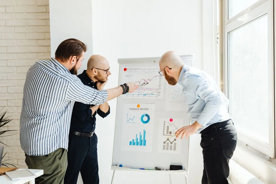 A polished, contemporary desk arrangement featuring a lightbox that says #TREND and a computer monitor displaying a social wall solution.
